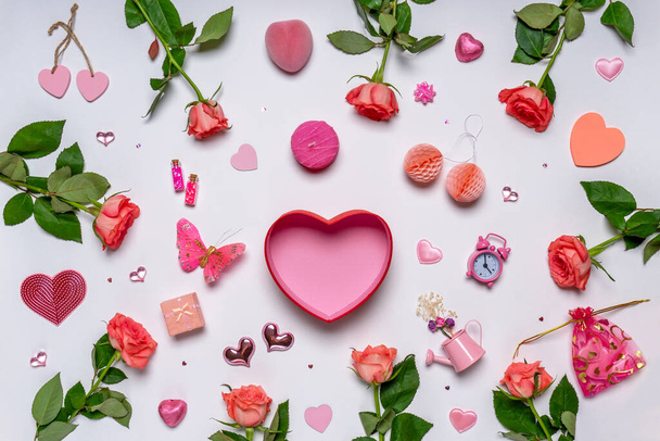 Roses, hearts, gifts, stylish feminine accessories and decorative items in pink color on white background. Empty gift box, greeting card for Valentine's, women's or mother's day. Mock up. - 写真・画像
