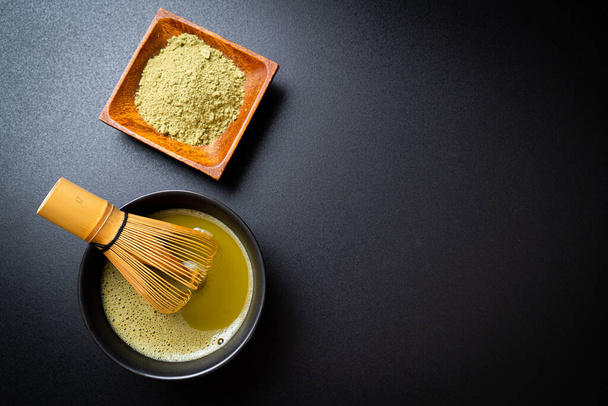 hot matcha green tea cup with green tea powder and bamboo whisk - Photo, Image