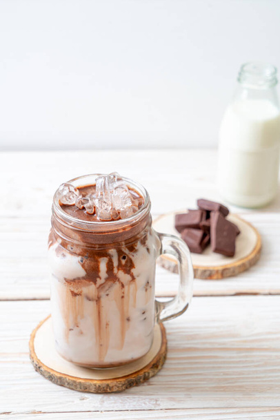Iced chocolate milkshake drink on wood background - Foto, Imagen