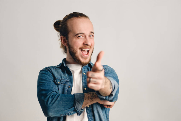 Attractive emotional bearded guy looking happy pointing at you and rejoicing over white background. Hey, you expression - Fotografie, Obrázek