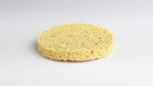round cosmetic sponge for washing from cellulose. selective shot, close-up. - Footage, Video