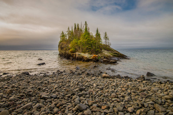 Rocky Shoreline in Minnesota on Lake Superior. Small island with green trees. North America - Photo, Image