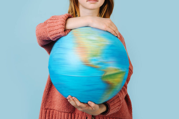 Rotation of the planet Earth. Girl holding a globe - Foto, Imagem