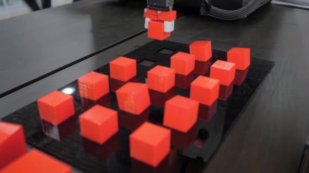 Pick and place robotic arm manipulator moving red toy blocks at robot exhibition - Footage, Video