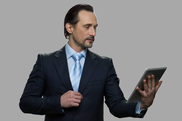 Confident mature businessman using digital tablet. - Photo, Image