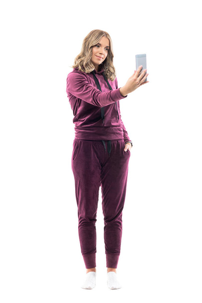 Happy young woman in casual leisure clothes taking photos with smart phone camera. Full body length isolated on white background. - Φωτογραφία, εικόνα
