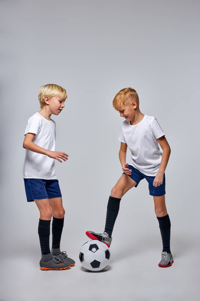 two caucasian active boys play football or soccer - Valokuva, kuva