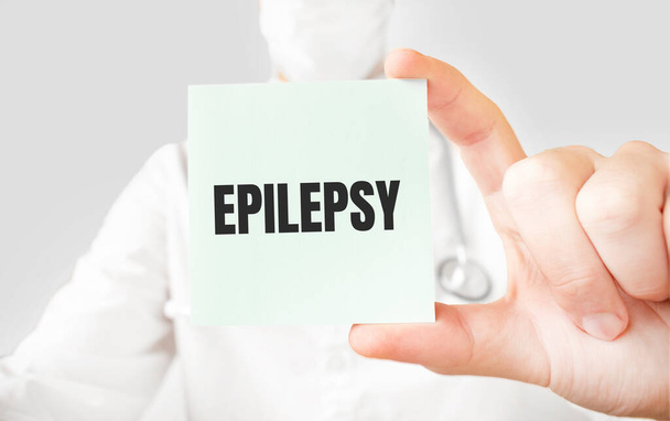 Doctor holding card in hands and pointing the word EPILEPSY - Fotoğraf, Görsel