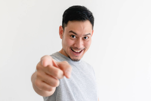 Man is pointing into the camera with an excited facial expression. - Foto, Imagen