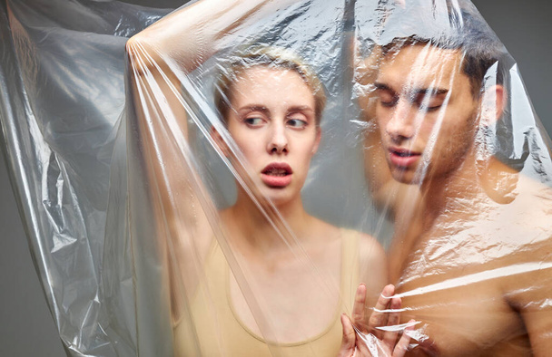 caucasian half-naked man and woman in polyethylene - Zdjęcie, obraz