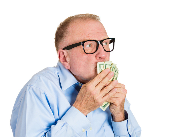 Зрілий чоловік цілує доларові купюри
 - Фото, зображення