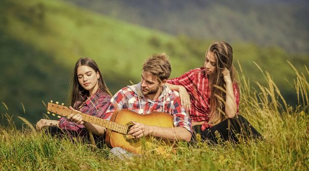 romantic picnic in tourism camp. campfire songs. group of people spend free time together. family camping. hiking adventure. happy men and girls friends with guitar. friendship. Feeling comfortable - Fotografie, Obrázek