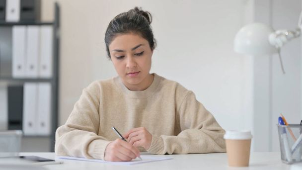 Young Indian Woman Writing at Work - Zdjęcie, obraz