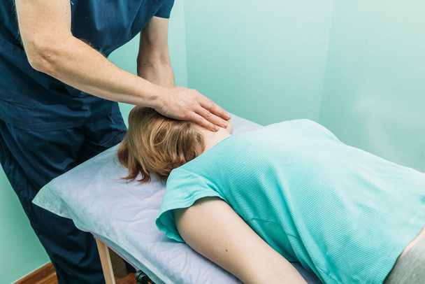 young woman getting professional neck treatment  at physiotherapist  - Valokuva, kuva