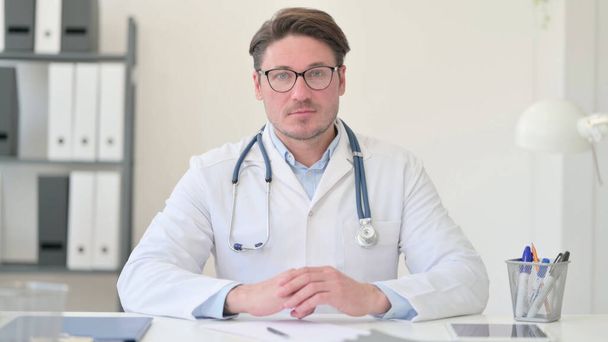Middle Aged Male Doctor Looing at the Camera  - Photo, Image