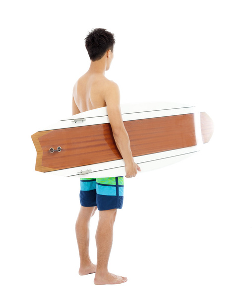 młody chłopak trzymając deskę surfingową na białym tle - Zdjęcie, obraz