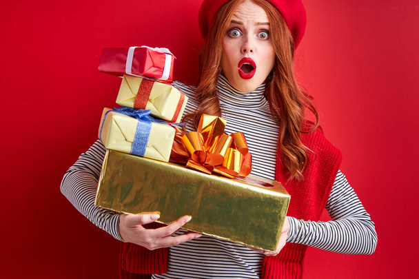 emotional redhead lady is pleasantly surprised to receive so many gifts - Zdjęcie, obraz