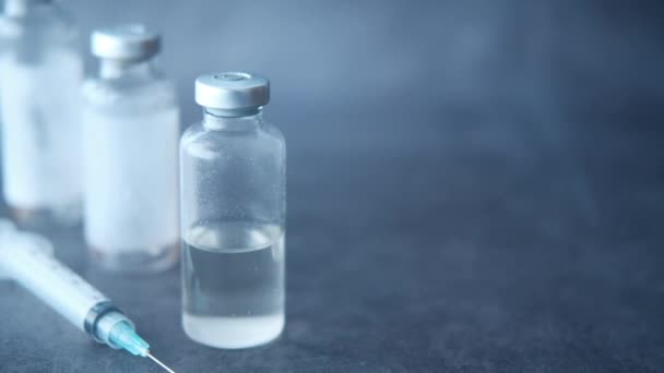 Close up of vaccine and syringe on black background - Footage, Video
