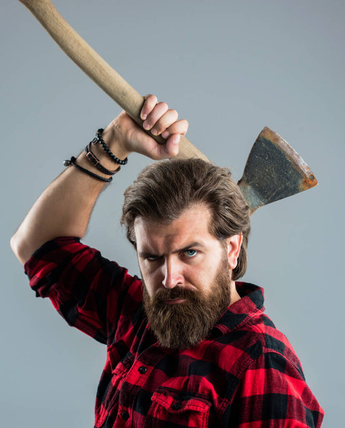 bearded male hipster in checkered shirt hold ax, camping - Фото, зображення