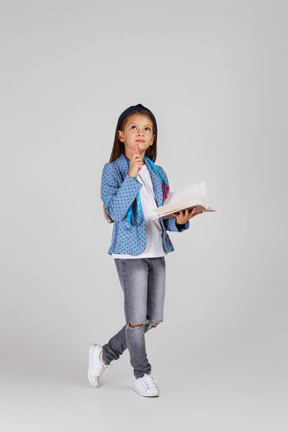 cute little girl holding tape measure and notebook - Fotó, kép