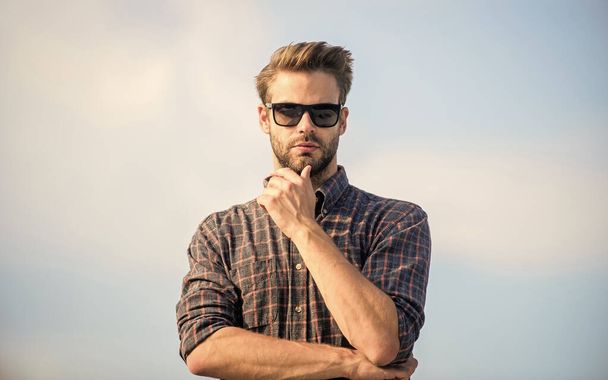 Guy wear casual outfit. macho man unshaven face. male fashion style. looking very trendy. sexy man sky background. businessman in glasses. confidence and charisma. men beauty and sexuality. Real men - Zdjęcie, obraz