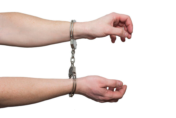 Hands in handcuffs.  Prisoner or arrested man , close-up of hands in handcuffs. Male hands in handcuffs. - Photo, Image