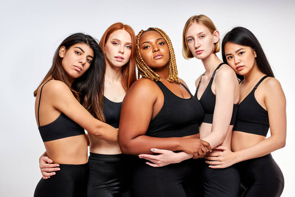 overweight african woman plus size model among slim skinny asian and caucasian ladies - Foto, Imagem