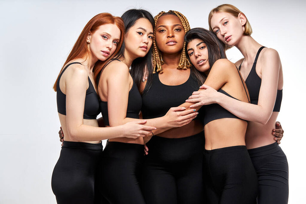 overweight african woman plus size model among slim skinny asian and caucasian ladies - Foto, Imagen