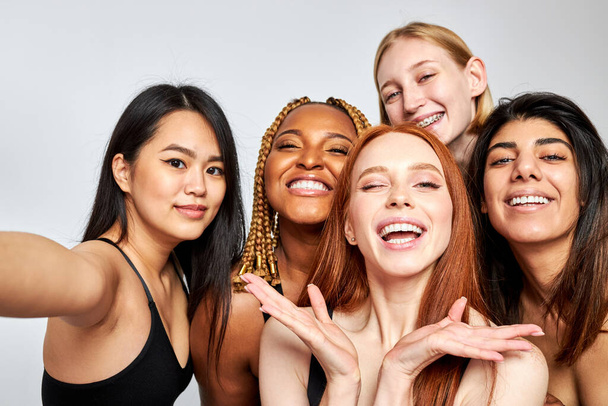 portrait of friendly interracial group of women models posing at camera - Fotó, kép