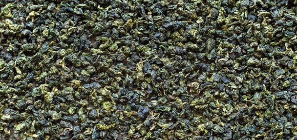 Close up dry rolled green tea leaves. - Photo, Image