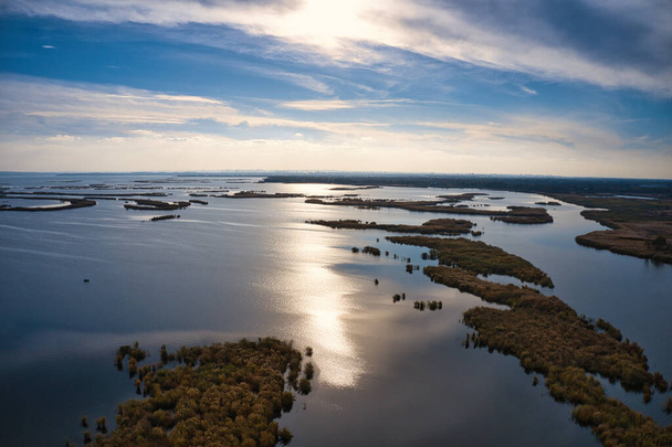 Irresistible floods on the Samara River on the Dnieper in Ukraine in the evening warm bright light. Aerial panoramic drone shot - Фото, изображение