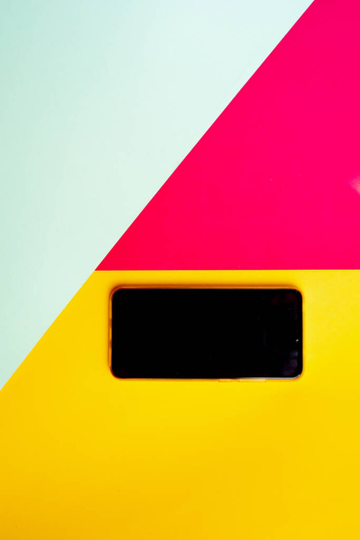 Empty phone isolated on pink yellow and blue background with copy space. - Fotografie, Obrázek