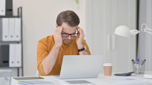 Tense Young Man having Headache at Work - Foto, Imagem
