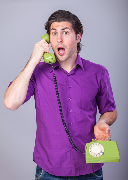 Handsome man with telephone on gray background. - Foto, Imagem