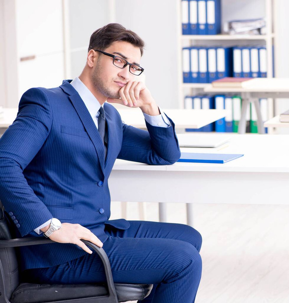 Young handsome businessman employee working in office at desk - Foto, immagini