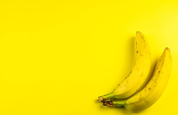 macro photo of yellow bananas over yellow background - Zdjęcie, obraz