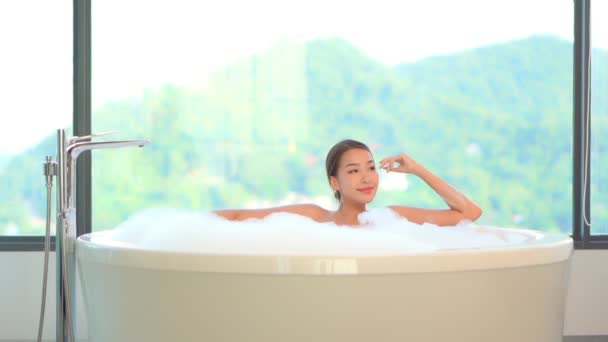кадры красивой азиатки, принимающей ванну с мыльными пузырями - Кадры, видео
