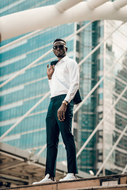 portrait of success and confident african businessman outdoor posing outdoor in modern city. - Фото, изображение