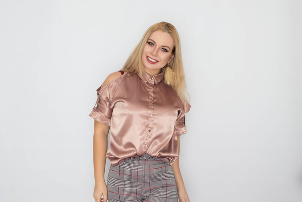 Smiling blonde business woman in pink blouse over white background - Foto, Imagen
