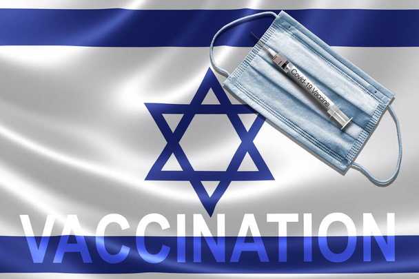 COVID-19 vaccination in Israel concept with face mask and syringe needle vaccine on Israeli Flag. - Photo, Image