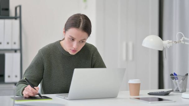 Young Woman with Laptop Designing on Graphic Tablet  - Photo, Image
