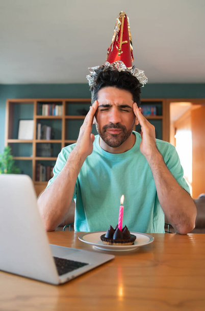 Man celebrating birthday online from home. - Фото, изображение