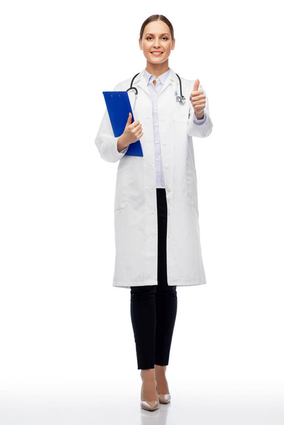 female doctor with clipboard showing thumbs up - Фото, зображення