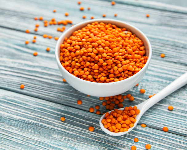 Organic healthy red lentils in bowl on a table - Foto, Imagen