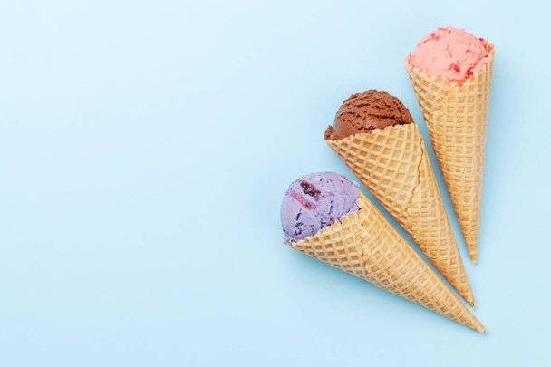 Berry, vanilla and chocolate ice cream sundae. Top view flat lay with copy space - Zdjęcie, obraz
