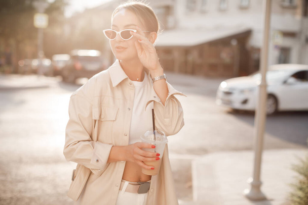fashion pretty woman with coffee at the street  - Photo, image