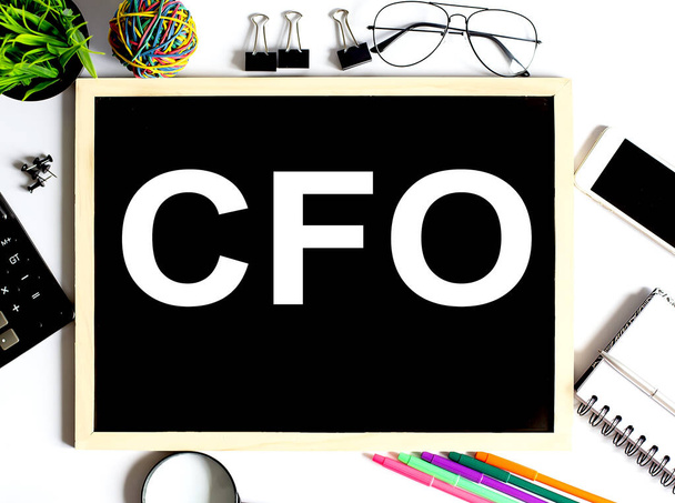 CFO Concept on the drawing board with office tools - Fotó, kép