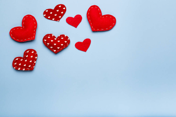 Blue background with red hearts, love concept, copy space, above - Photo, Image