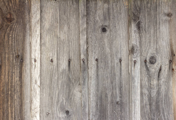 Old wooden background with cracks and nails, darkened and weathered boards. - Photo, Image