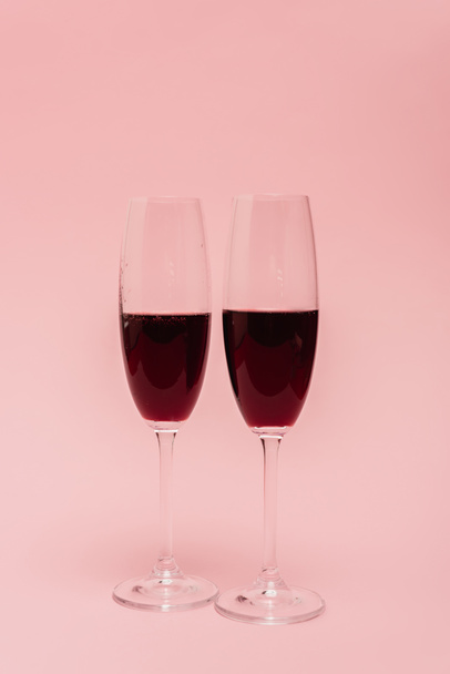 red wine in glasses isolated on pink - Photo, image